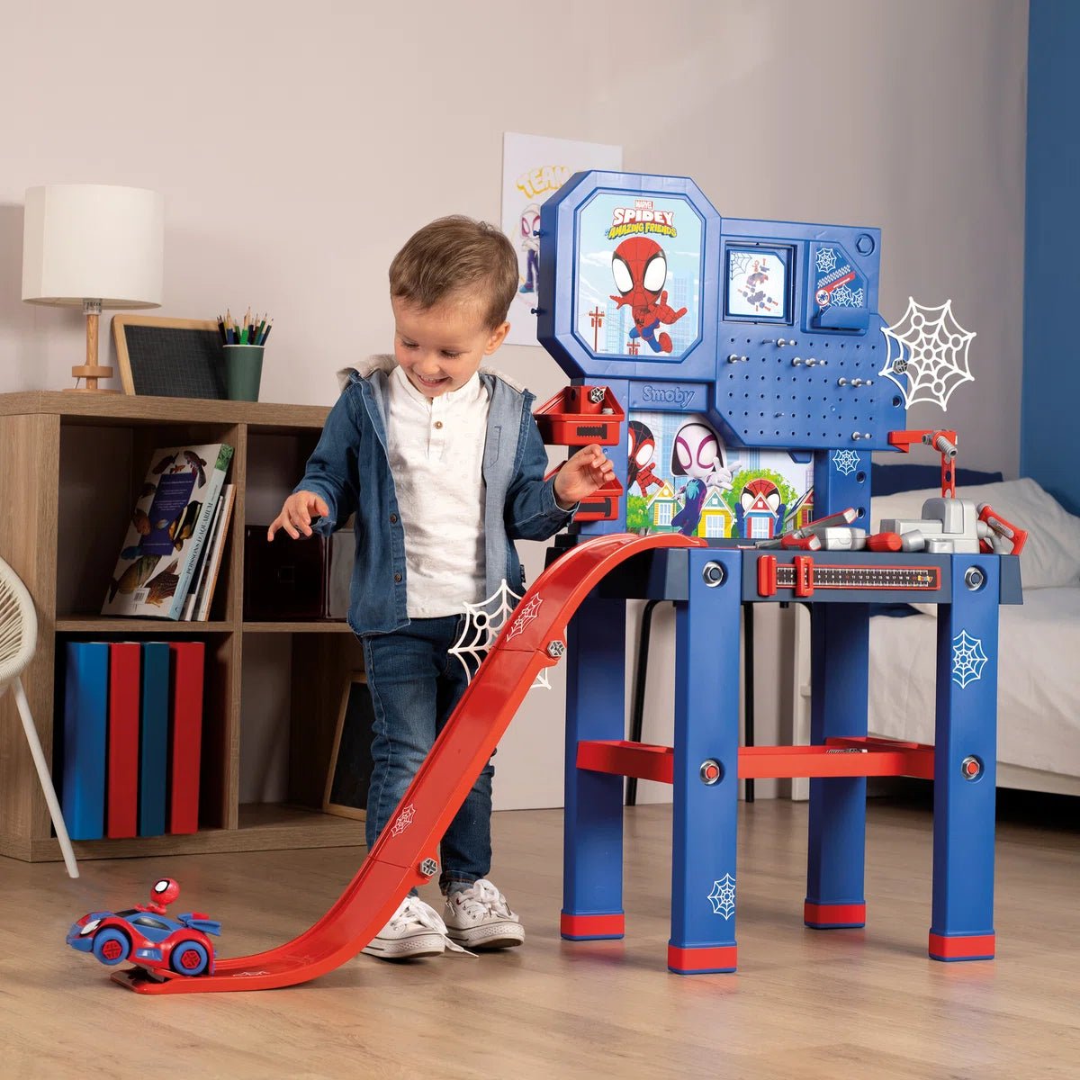 Spidey-themed blue and red workbench toy with tool panel, shelves, and red slide
