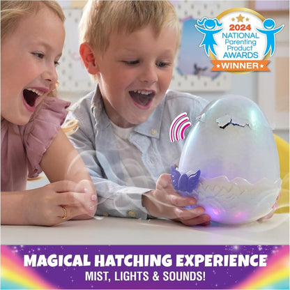 Glowing hatching egg toy with small blue creature, played by children at table