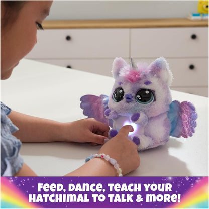 Purple and pink plush unicorn with wings and glowing light under belly