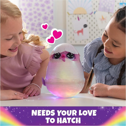 Purple and pink glowing hatching egg toy with baby creature, held by kids