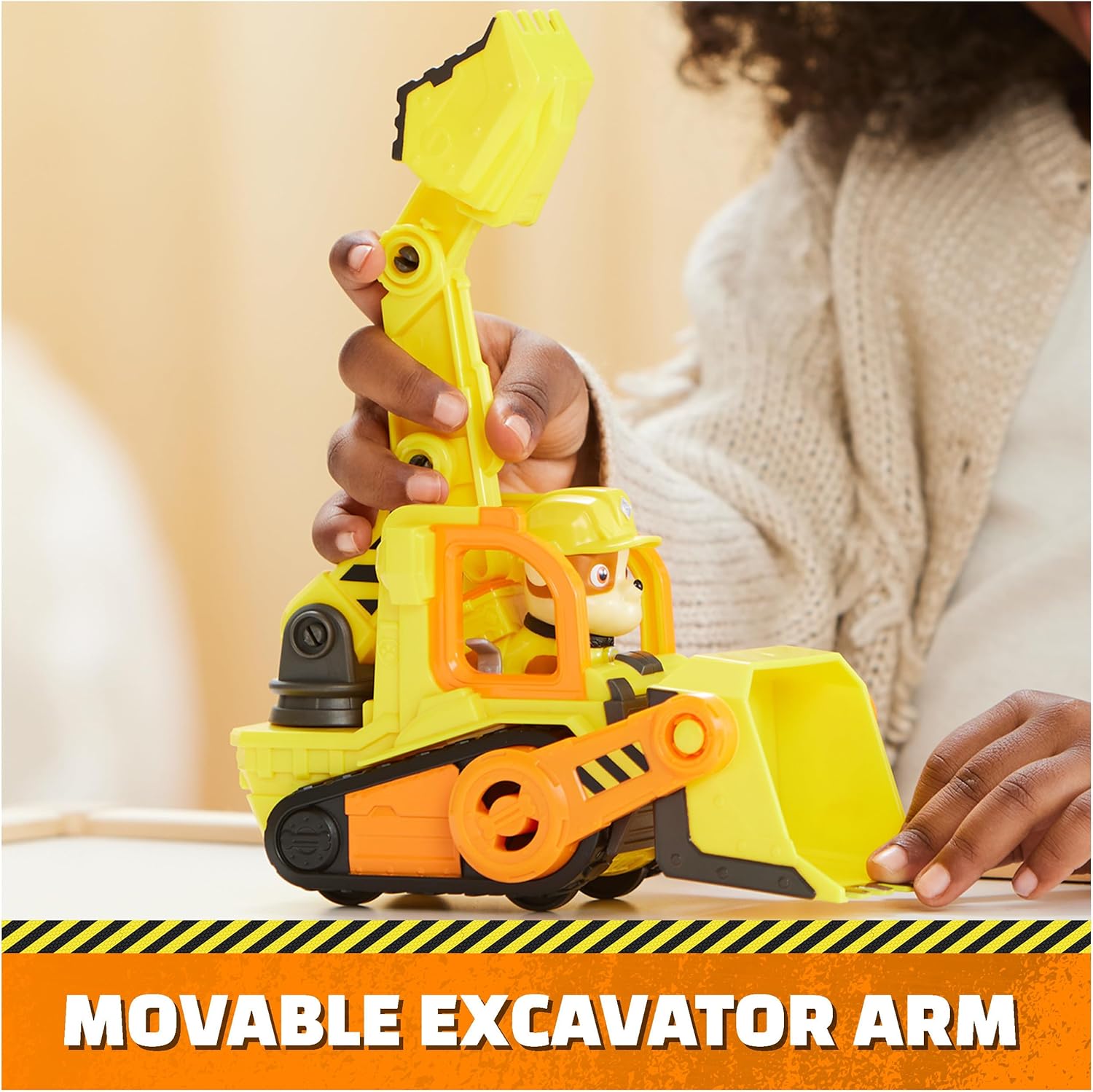 Yellow bulldozer toy with movable excavator arm and Rubble figure in cab