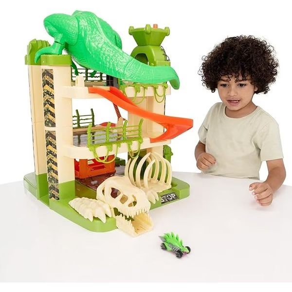 3-level dinosaur car garage playset with green T-rex, red lift, and roller tracks
