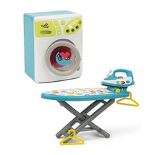 Toy washing machine with front window and a blue steam iron on an ironing board