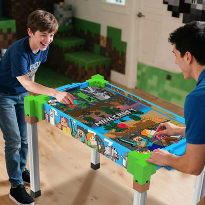 Minecraft air hockey table in use; two players slide pucks on the pixel playfield